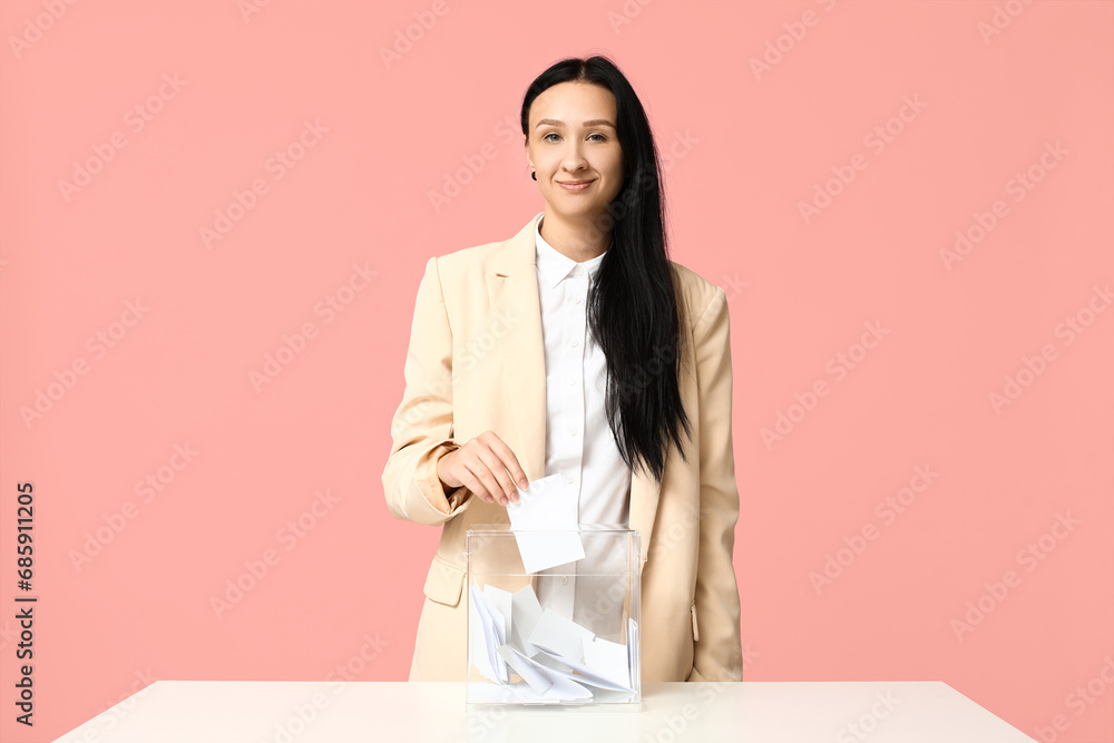 Voting woman near ballot box on pink background Voting woman near ballot box on pink background