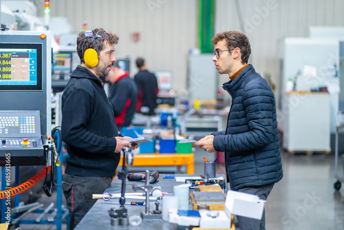Engineers during a quality control in a cnc factory photo
