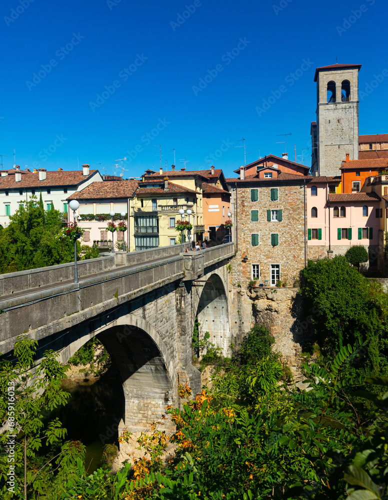 Scenic view of ancient arched bridge Ponte del Diavolo across Natisone river in small Italian town of Cividale del Friuli - obrazy, fototapety, plakaty 