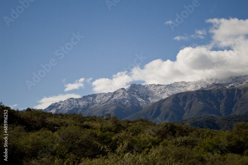 Landscape of snowy mountains and clouds photo