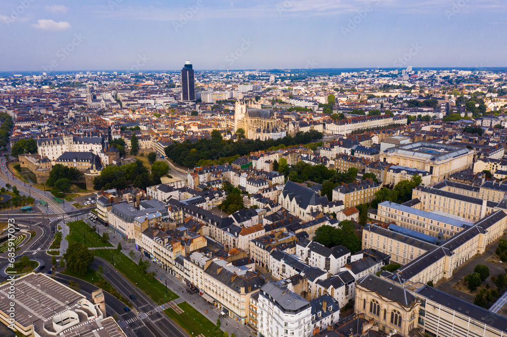 Panoramic aerial view of modern cityscape of Nantes on banks of Loire river on summer day, France