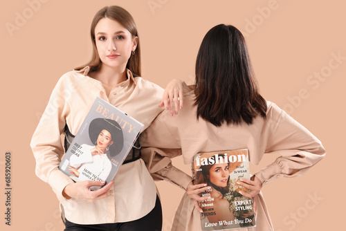 Young women with magazines ...