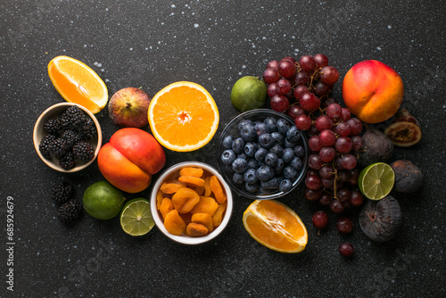 Assortment of fresh exotic fruits and berries on concrete table, flat lay