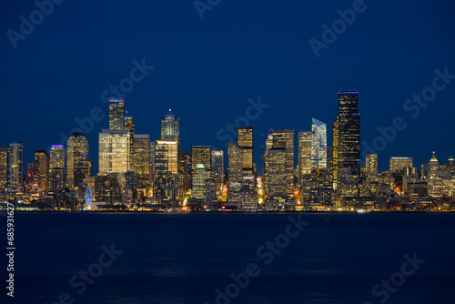 Seattle central business district across Elliott Bay during blue hour illuminated