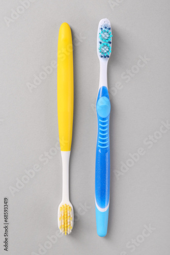 Different toothbrushes on light background  flat lay