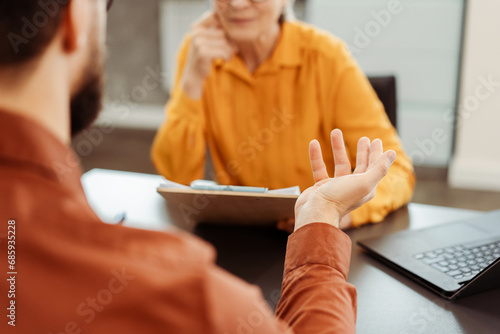 Cropped view of the business woman, employer listening candidate at job interview photo