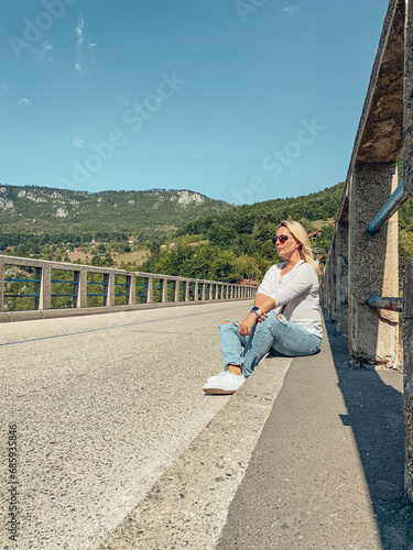 Woman resting on the Djurdjevica  bridge photo