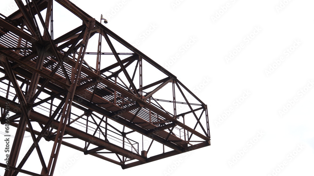 Building structure of rusty steel in construction, white sky