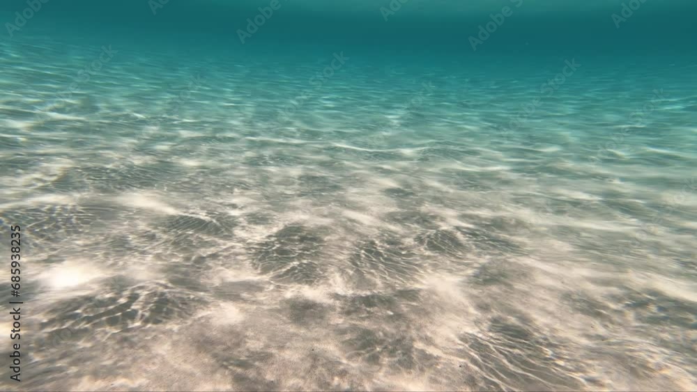 Underwater video of weaves of sunlight on the white sandy bottom Underwater video of weaves of sunlight on the white sandy bottom