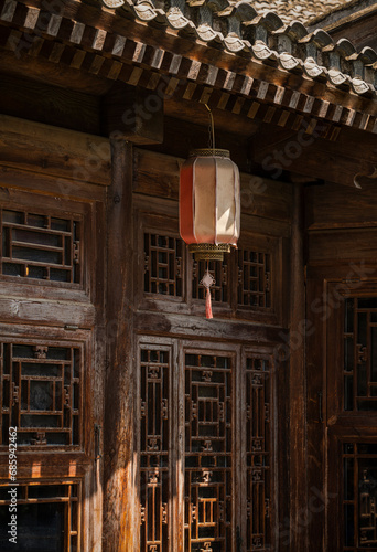 Red lantern hanging on eaves of traditional house. Beijing, China