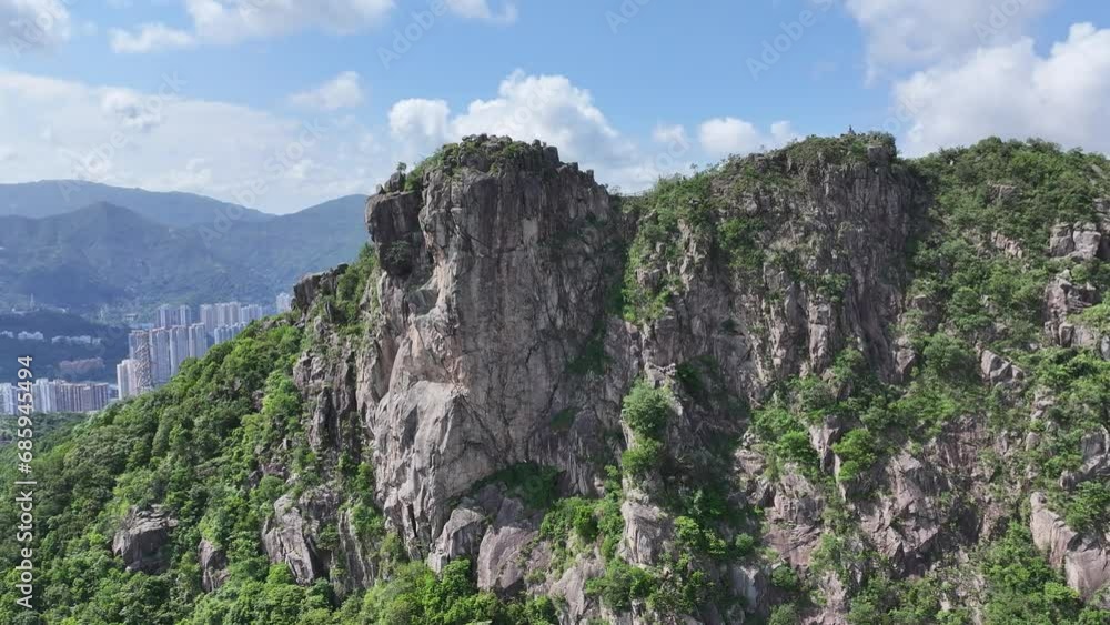 Lion Rock mountain in Kowloon Peninsula Hong Kong sunny aerial drone skyview shot. Popular travel destination in Asia. China. Rock climbing cliffs Lion Rock mountain in Kowloon Peninsula Hong Kong sunny aerial drone skyview shot. Popular travel destination in Asia. China. Rock climbing cliffs