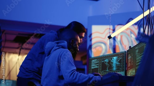 Teamworking spies contracted by government to do international espionage warfare on other countries, using advanced technology computer equipment to infiltrate past protection firewalls