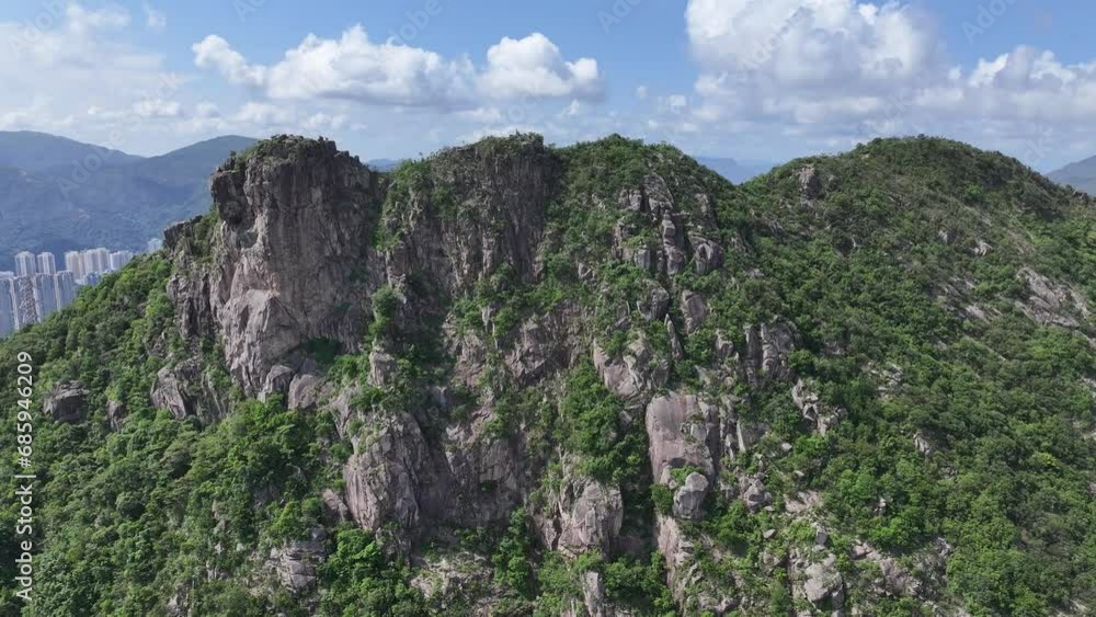 Lion Rock mountain in Kowloon Peninsula Hong Kong sunny aerial drone skyview shot. Popular travel destination in Asia. China. Rock climbing cliffs Lion Rock mountain in Kowloon Peninsula Hong Kong sunny aerial drone skyview shot. Popular travel destination in Asia. China. Rock climbing cliffs