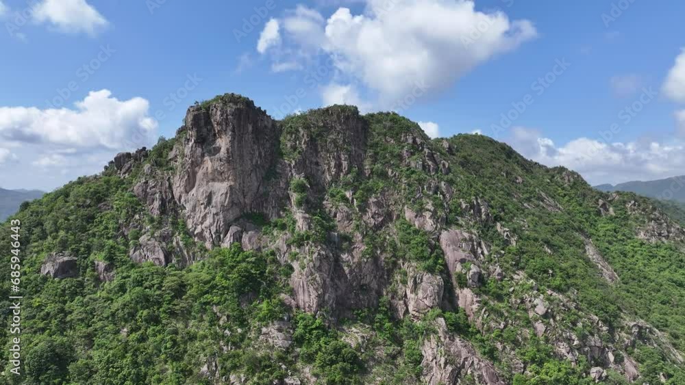 Lion Rock mountain in Kowloon Peninsula Hong Kong sunny aerial drone skyview shot. Popular travel destination in Asia. China. Rock climbing cliffs Lion Rock mountain in Kowloon Peninsula Hong Kong sunny aerial drone skyview shot. Popular travel destination in Asia. China. Rock climbing cliffs
