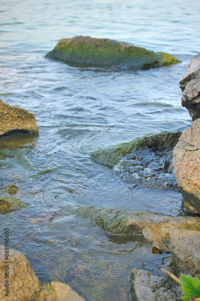 Water flowing around rocks at beach Water flowing around rocks at beach