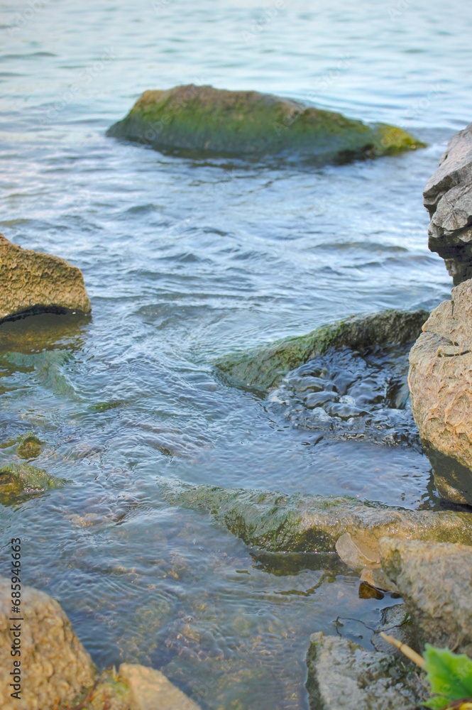 Water flowing around rocks at beach