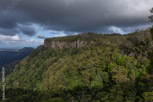 The tree covered cliffs at the edge of the escarpment at Springbrook in Lamington National Park on the Gold Coast in Queensland, Australia.