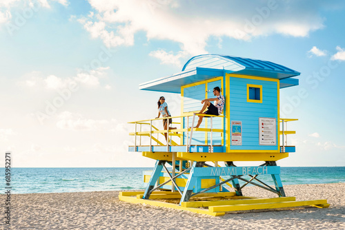 Miami South Beach Florida US, a couple by a lifeguard hut during Sunrise Miami Beach, men and woman on the beach © Fokke Baarssen