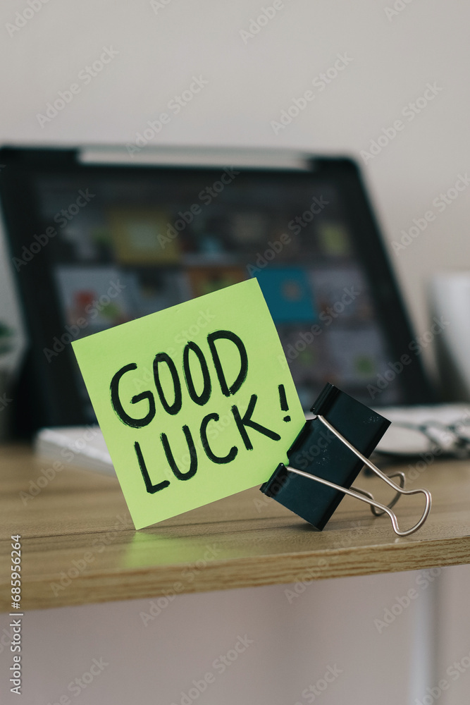 Fototapeta premium Good Luck text written on paper notes on a work desk