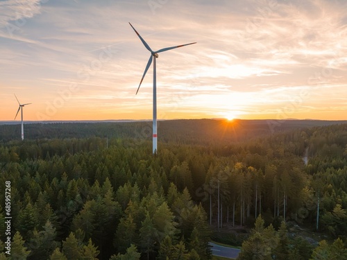 Wind turbine for energy generation at sunset in the forest, Enkloesterle, Black Forest, Germany, Europe photo