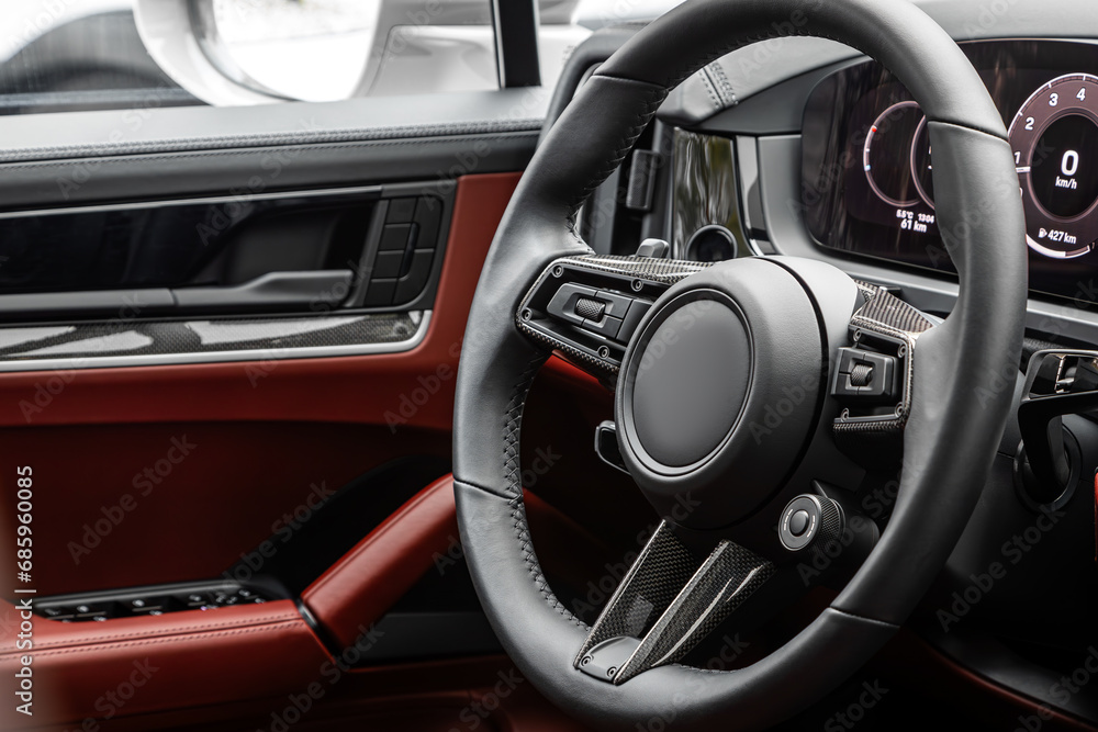 car Interior - steering wheel, shift lever and dashboard, climate control, speedometer, display  in luxury car.