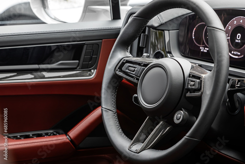 car Interior - steering wheel, shift lever and dashboard, climate control, speedometer, display in luxury car.