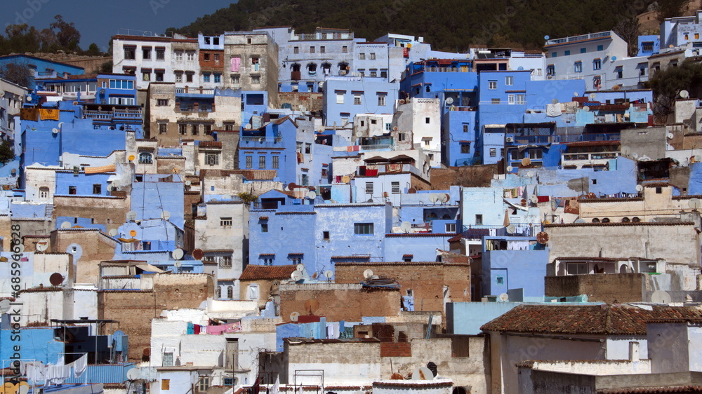 Blue and white buildings on a hill in the medina, in Chefchaouen, Morocco