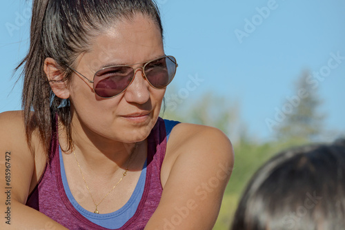 Portrait of a Latina tourist with glasses and a beautiful tan.