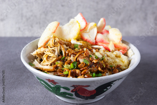 Bubur ayam or Chicken Porridge, Indonesian traditional food consist of white rice porridge, shredded chicken, fried soybean, crackers, leek.
