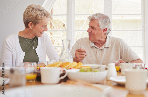 Breakfast, talking and lunch with senior couple, eating and happy together in a home. Love, support and care on a dining room with a smile and food with bonding in the morning with fruit in house
