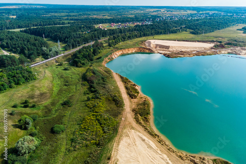 Fototapeta Naklejka Na Ścianę i Meble -  Aerial view of a flooded sand quarry with blue water