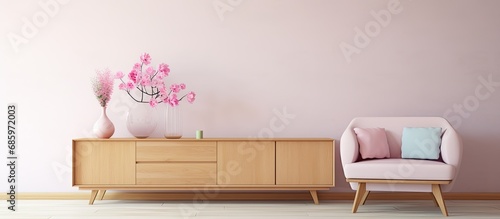 Pastel pink sofa in contemporary living room with flower-filled vases on wooden commode.