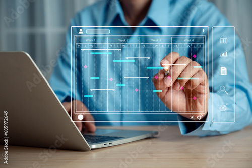 Businessman working with Gantt chart schedule , with a planning software, Corporate strategy for finance, operations, sales, marketing.