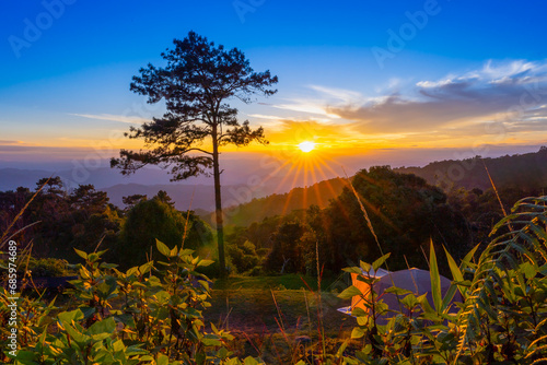 Sun rays shine through trees on a hill mountain in Huai Nam Dang National Park at sunset. View mountain landscape Tourist Attraction in Chiang Mai, Thailand