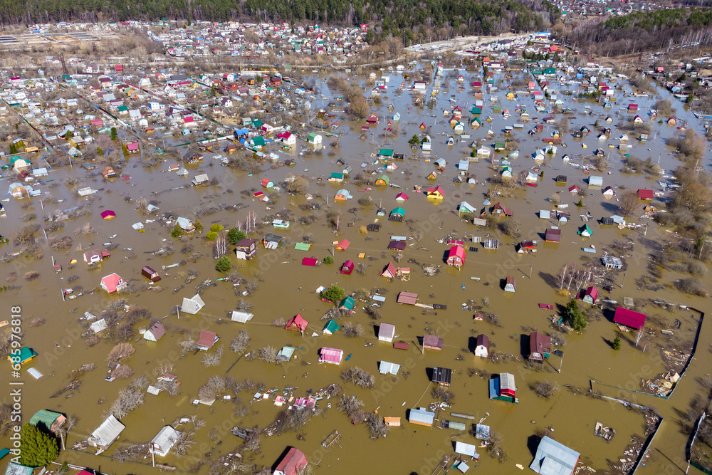 Obraz premium Private sector with small country houses flooded during the spring flood, flooding in rural areas from the air