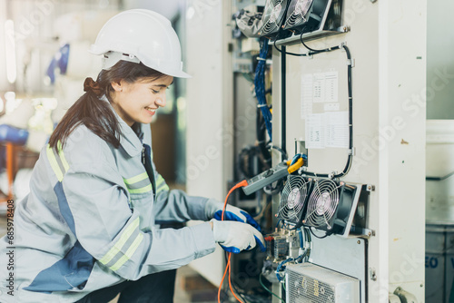 Electrician women worker checking repair maintenance fix service electric system. female electrician engineer setup testing electric cable at main power line.