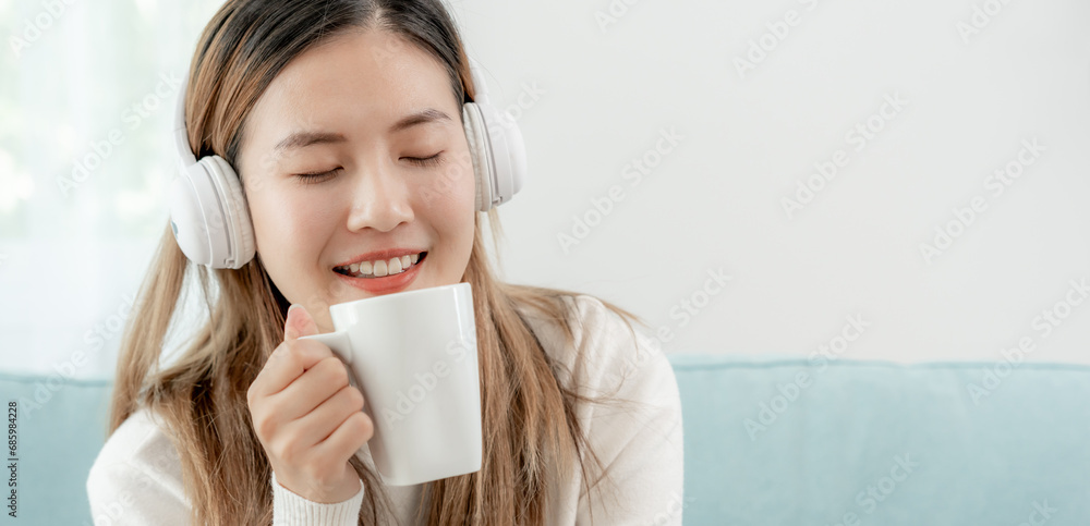 Joyful young Asian women in wireless headphones sitting and enjoy music, having fun, listening to music, raising his arm, dancing to favorite song, enjoying cool soundtrack, happy life, recreation Joyful young Asian women in wireless headphones sitting and enjoy music, having fun, listening to music, raising his arm, dancing to favorite song, enjoying cool soundtrack, happy life, recreation