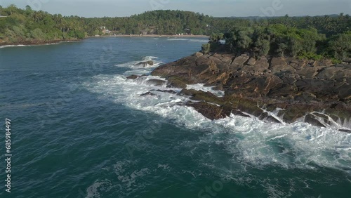 Establishing Aerial Drone Shot Revealing Hiriketiya Bay behind Headland in Southern Sri Lanka photo