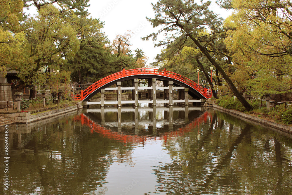 The red bridge serves as the entrance to Sumiyoshi Shrine in Osaka Prefecture, Japan, a renowned and historic shrine. The red bridge serves as the entrance to Sumiyoshi Shrine in Osaka Prefecture, Japan, a renowned and historic shrine.