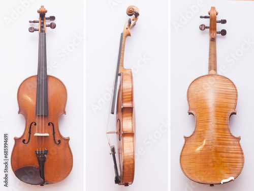 Antique fine violin from front, back and side on white background
