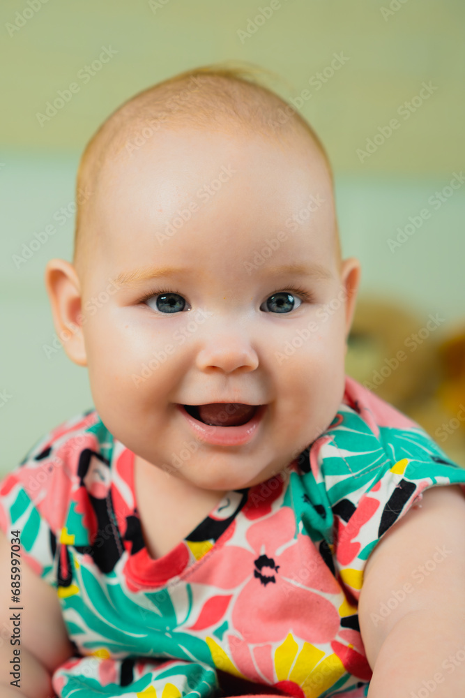 Portrait of a cute little baby girl in a colorful shirt. Portrait of a cute little baby girl in a colorful shirt.