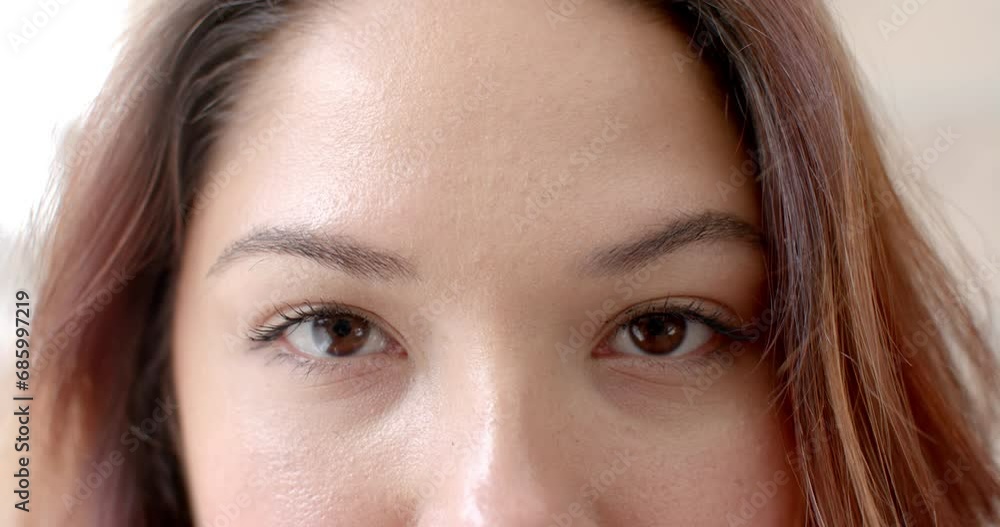 Portrait close up of eyes of happy biracial woman smiling at home, copy space, slow motion Portrait close up of eyes of happy biracial woman smiling at home, copy space, slow motion