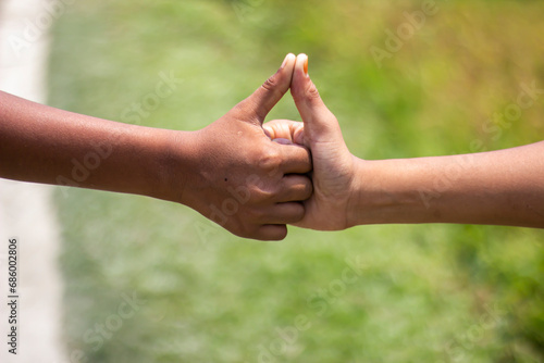Two human hands with thumbs pointing up and blurred background © Rokonuzzamnan