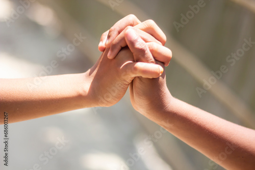 Two people's hands are clenched fists and blurred background