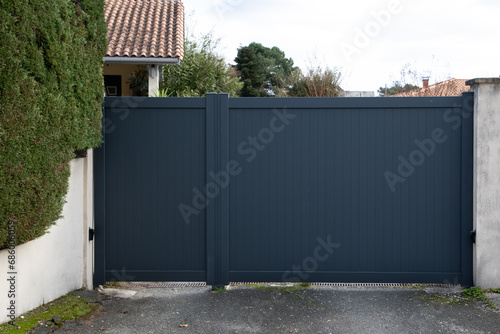 Aluminum gray high modern grey portal closed of suburb garden with pedestrian door house