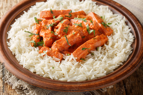 Korvstroganoff is the Swedish version of a dish known as beef Stroganoff prepared with a Swedish sausage falukorv with a side dish of rice closeup on the plate on the table. Horizontal photo