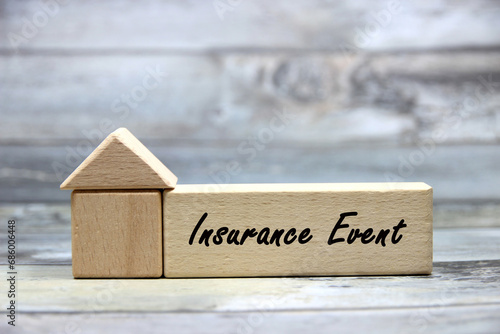 "Insurance Event" text or message short word letter on wood block with wood pantern background.Copy space.Insurance concept.