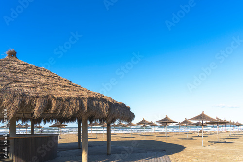 Adriatic sea  Albania coast beautiful sky   Straw umbrella  Gjiri i Lalzit 