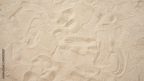 Image of the surface of a fine golden sand beach. It is sand that is pure, clean, and does not contain filth or garbage. The upper surface has traces of where various equipment was placed. © Darunee
