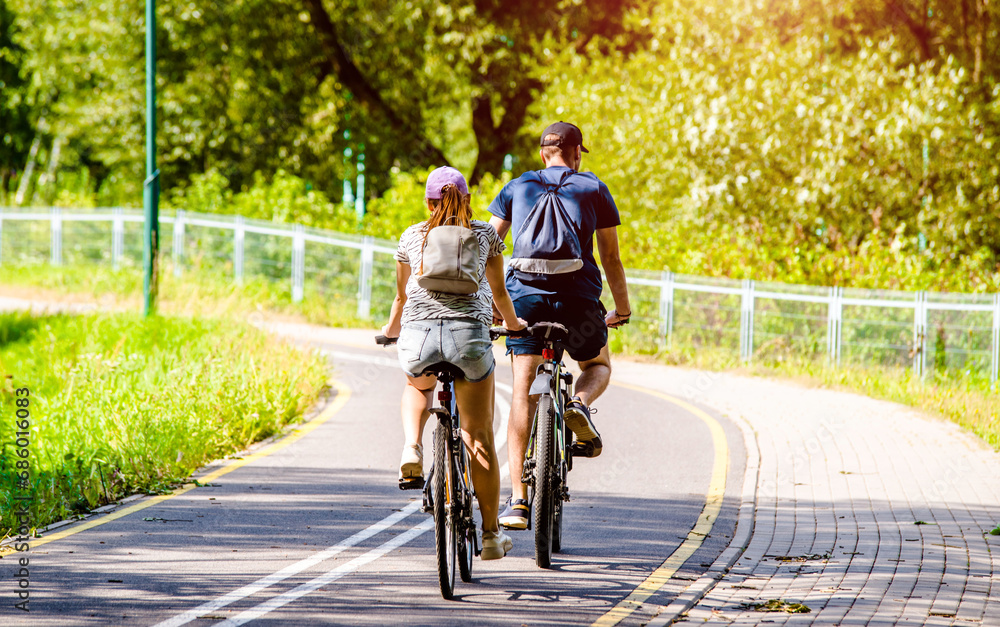 Cyclists ride on the bike path in the city Park

